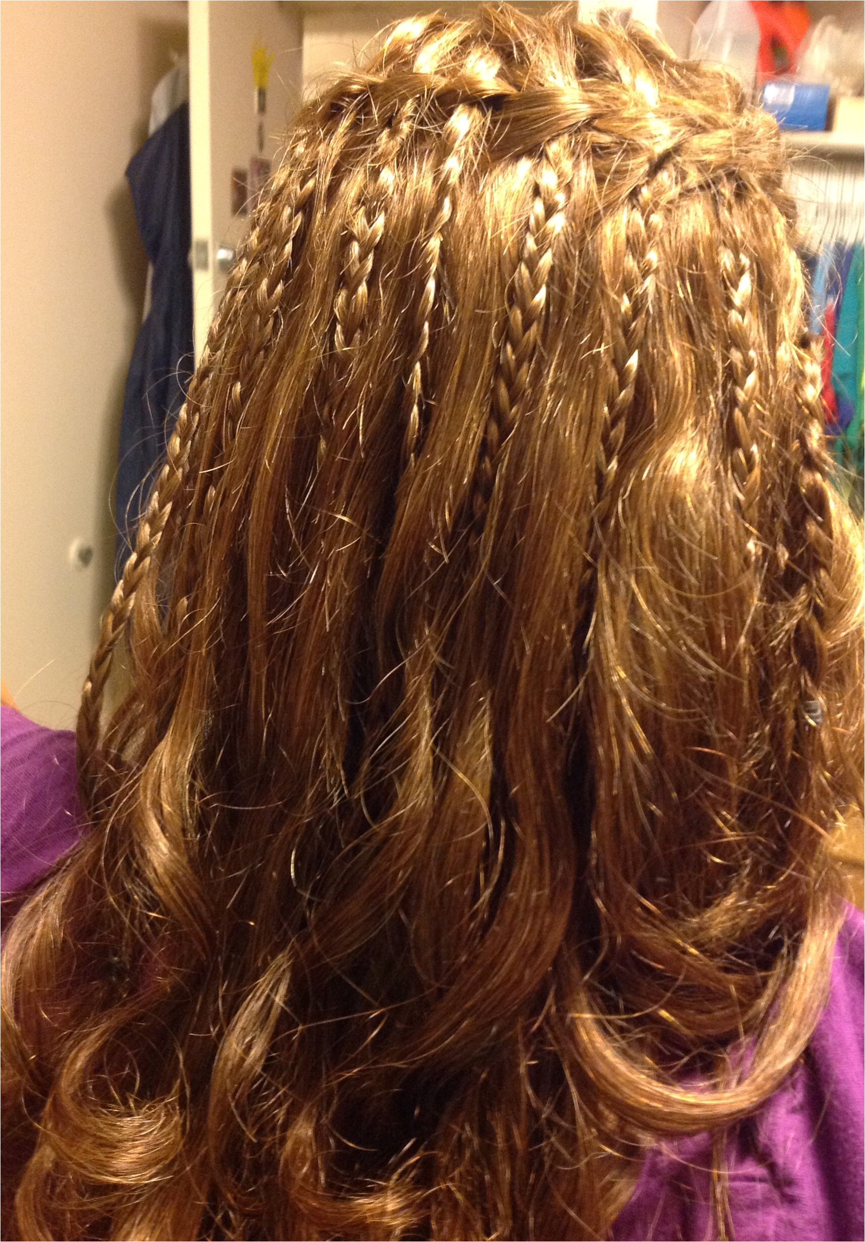 Waterfall braid then braid the strands that "waterfall" then curl the ends