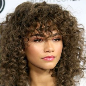 11 Hairstyles for Curly Hair 11 Cute Bang Styles to Try Allure