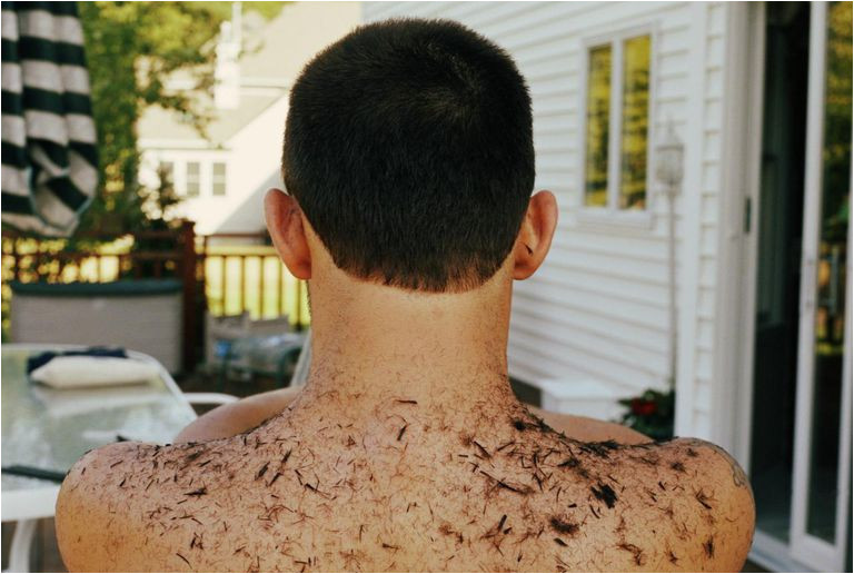 Bare chested man with hair cut from head on back