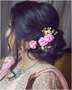 Slay the hair on your engagement pink rose lower bun loose strands Hair Artistry By Archana