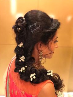 Gorgeous romantic bridal hairstyle for Sangeet Hairstyle by Team Swank Braids with flowers