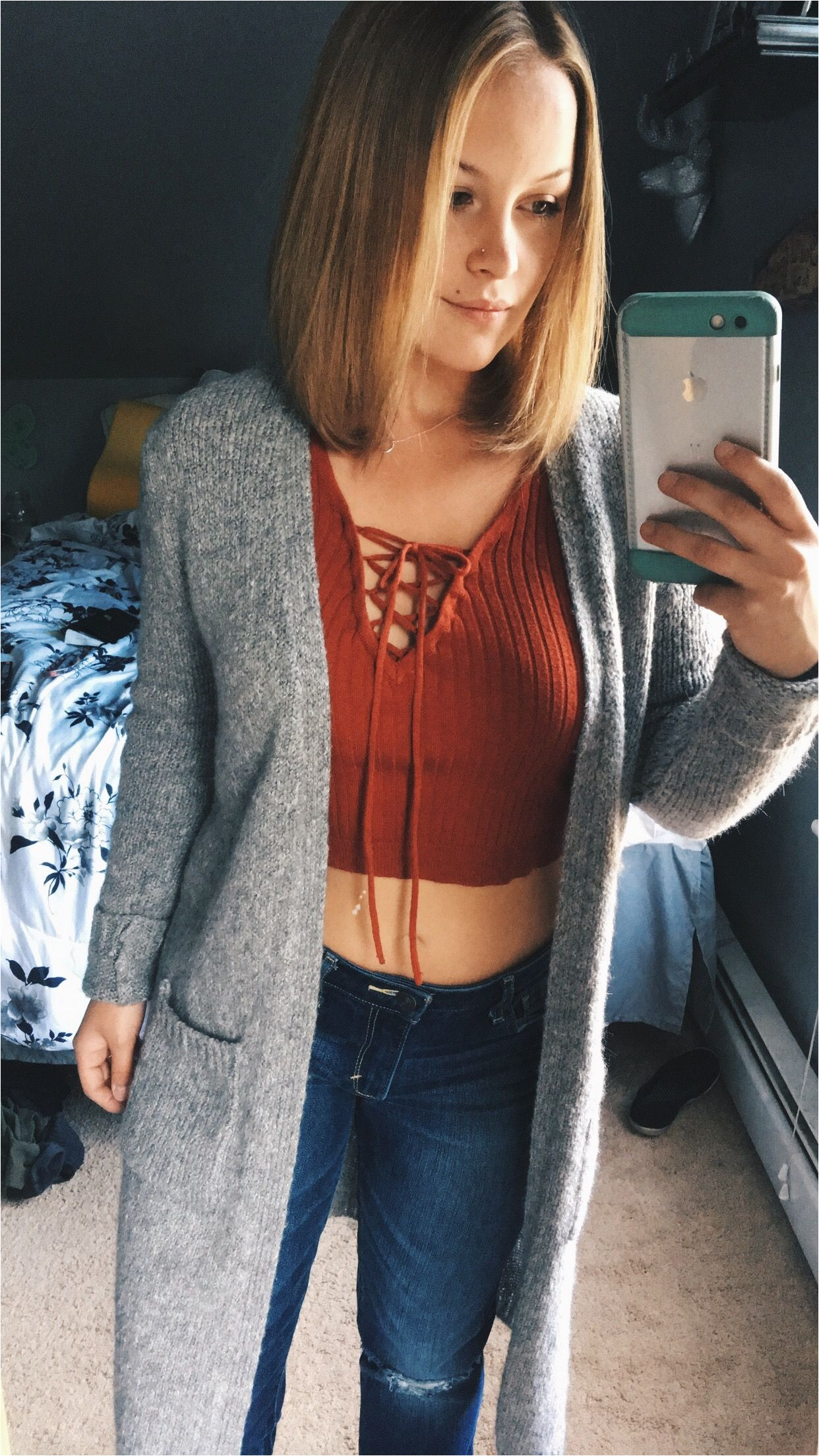 Long bob lob cute fall outfit maroon lace up crop top and xtra long sweater dark ripped jeans straightened dirty blonde short hair above shoulders