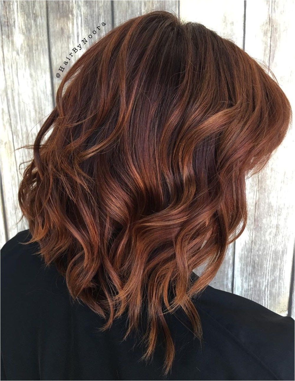 layered dark brown hairstyle with medium brown highlights