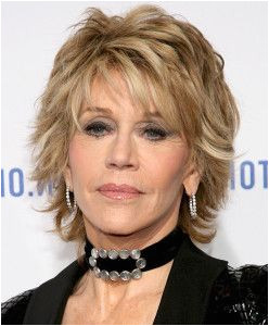 medium layered blonde messy hairstyle with bangs for older women over 60