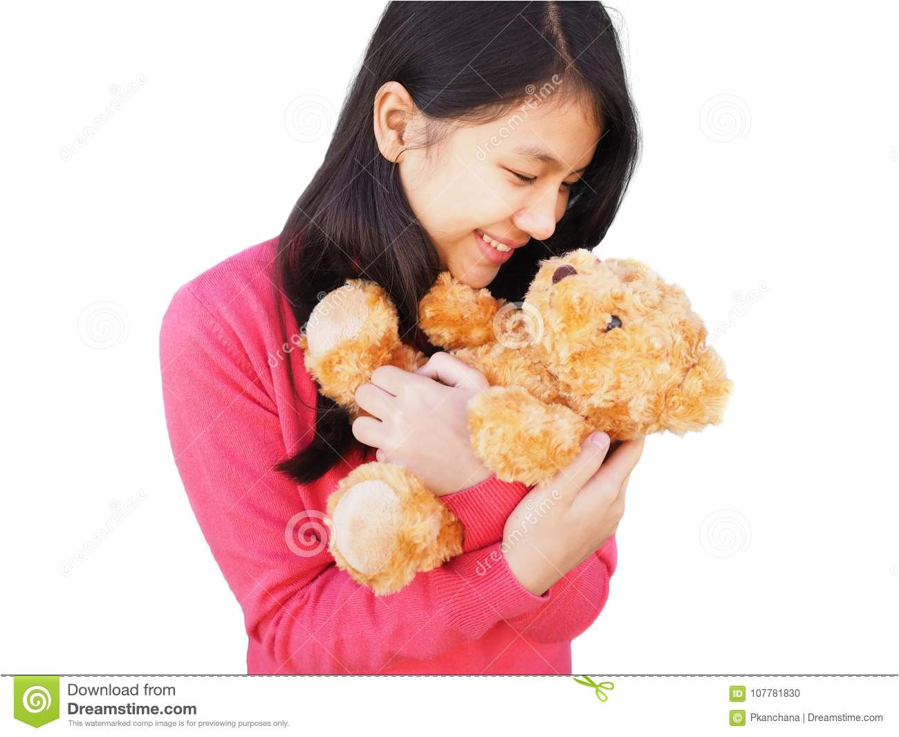 Asian girl with long hair smiling to brown teddy bear in her arm