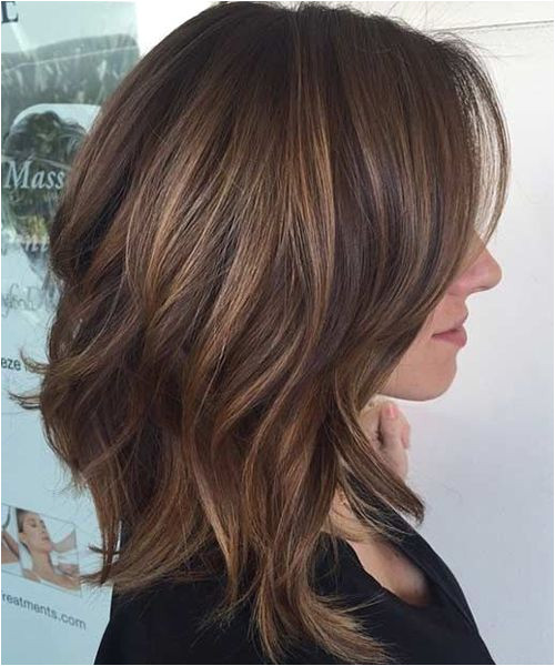 Cute brunette highlighted shoulder length medium hair with long shaggy layers