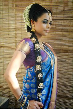 Traditional Indian bride wearing bridal saree and jewellery hairstyle Indian Bridal Hairstyles Indian