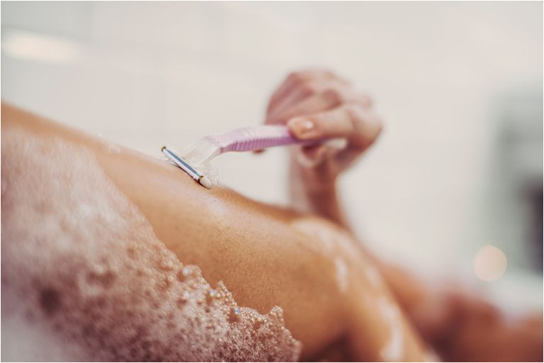 Woman shaving her legs