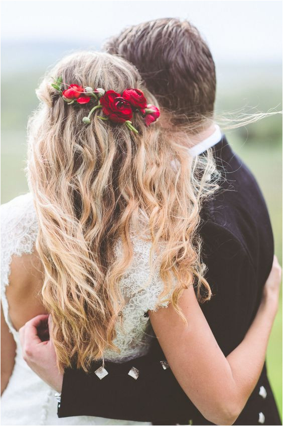 Red flower detail in wedding hairstyle with long messy waves