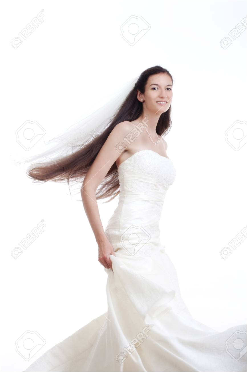portrait od a bride with long dark hair in wedding dress isolated on white Stock