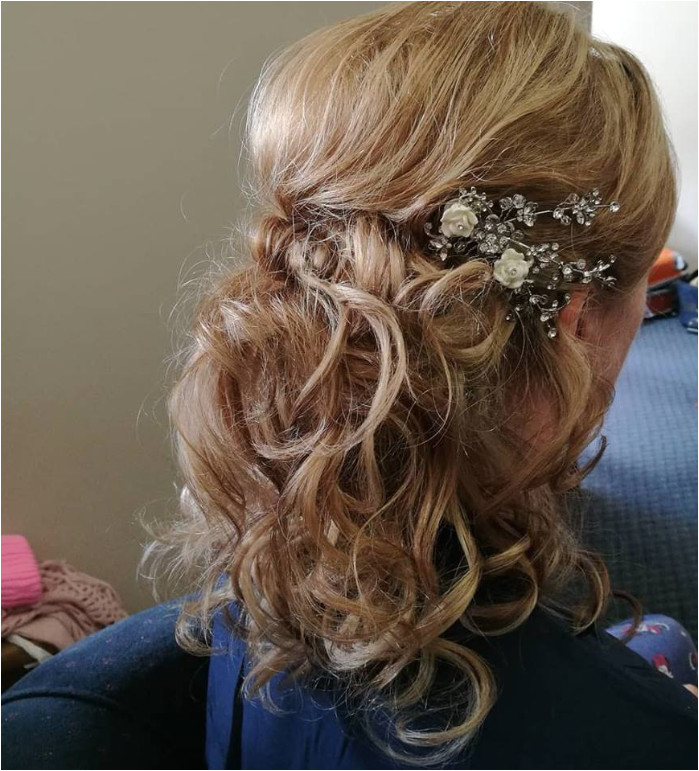 Half up half down bridal hair style Bit of height and a lovely side sweep at the front Curls were made using heated rollers and then individually styled