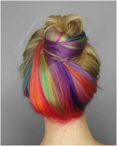 Give the unicorn hair trend a try with a subtle rainbow under dye in tie dye brights