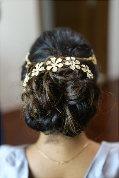 messy bun wavy bun bun with hair accessory engagement hairstyle floral hair…