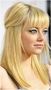 emma stone half up hairstyle with dramatic cat eye and full bangs