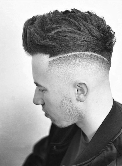 A picture of a mens short fade haircut with a surgical line