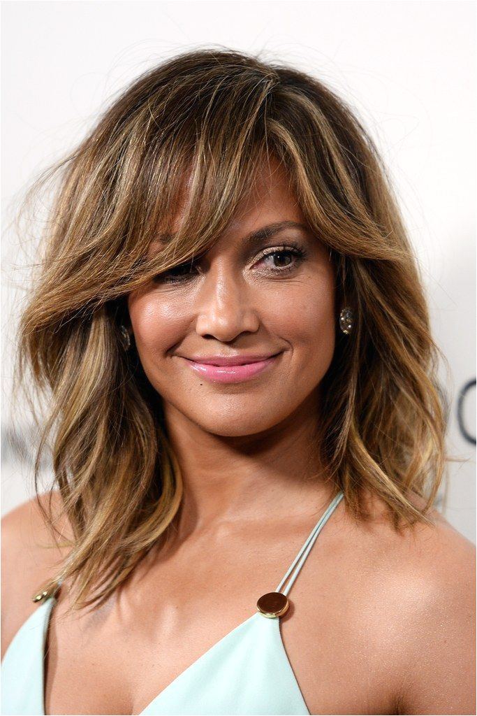 Not sure if you want to mit to full on bangs Try a tousled sideswept look like JLo