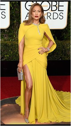 Golden Globes 2016 Jennifer Lopez The Shades of Blue star outdid even her past memorable red carpet looks in a spectacular yellow Giambattista Valli cape