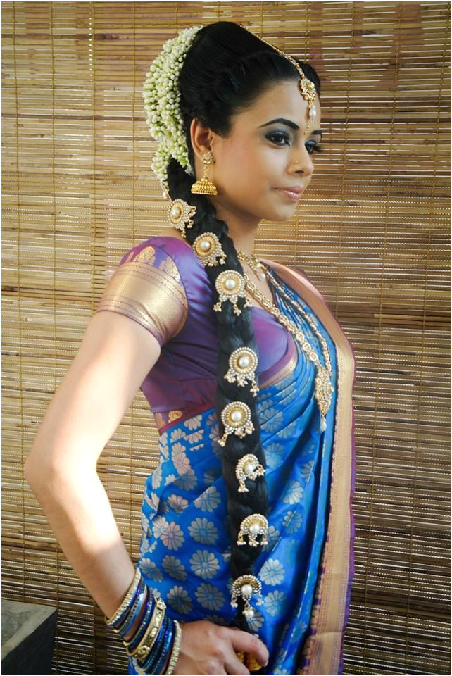 Traditional Indian bride wearing bridal saree and jewellery hairstyle