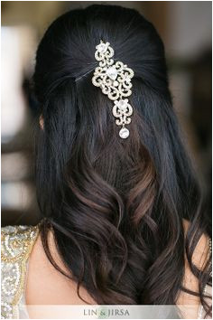 Loose wavy hairdo with a simple stoned brooch or large chandelier earrings with bobby pins