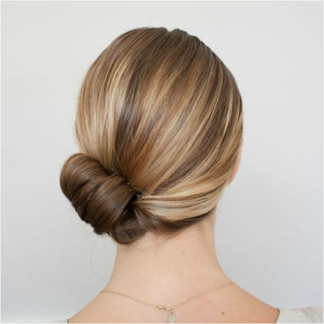 Sweep your strands to one side roll your ends up to create a barrel roll at the base of your neck to this glam holiday updo