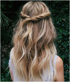 Twisted half up half down hairstyle with loose waves for a bohemian and romantic