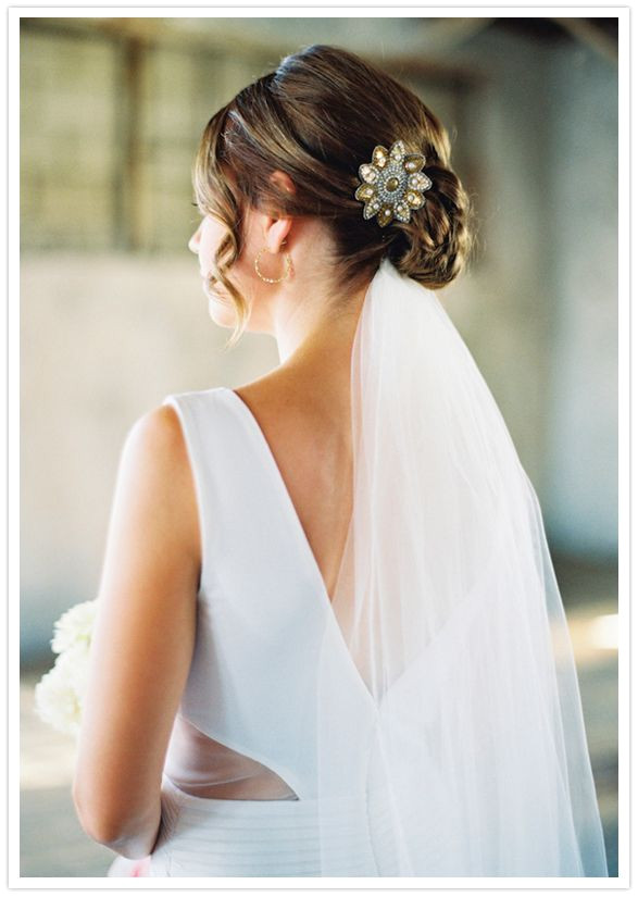 wedding hair style low bun veil underneath clip side ringlets