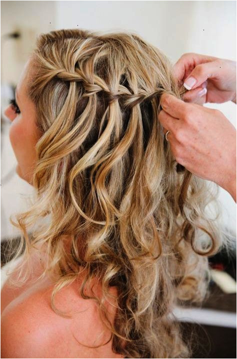 Loose curls with a simple but elegant braid detail makes the perfect beach wedding hairstyle