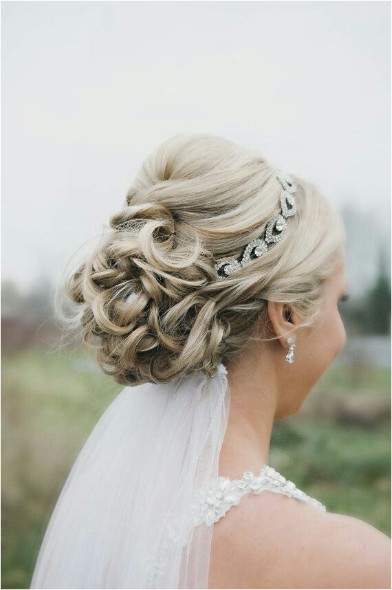 Wedding updo with headband and veil underneath