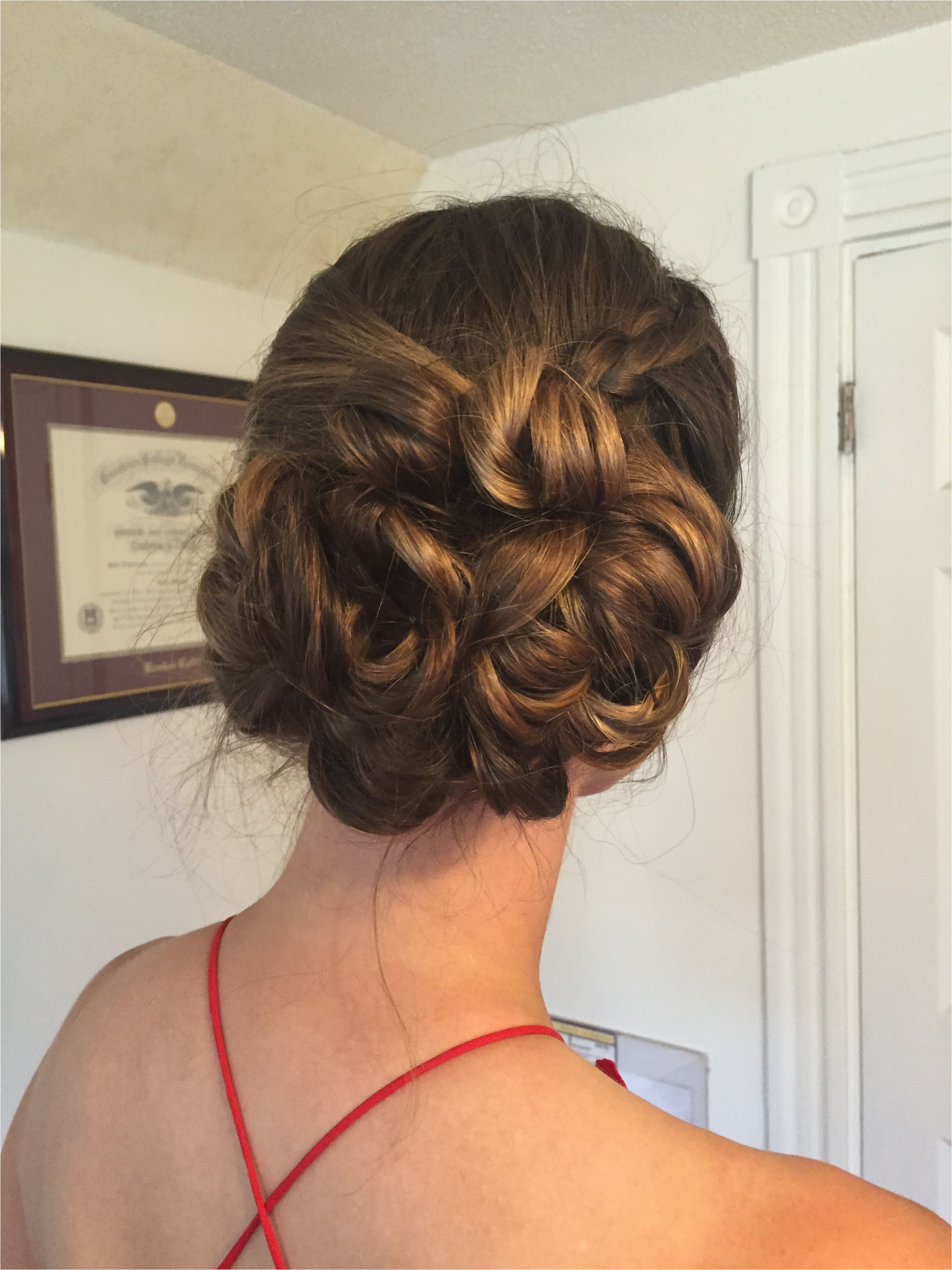 Low side bun updo for wedding guest or bridesmaid hair with side braid and pinned curls