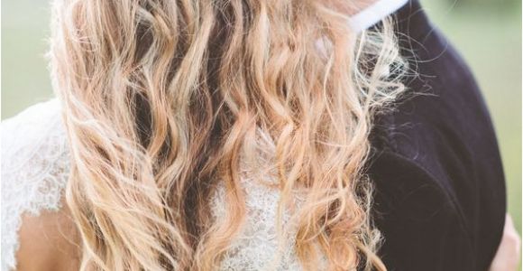 Wedding Hairstyles for Long Hair Down with Flowers Red Flower Detail In Wedding Hairstyle with Long Messy Waves